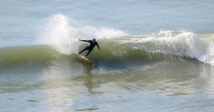 John Purnell surfing Paulownia board